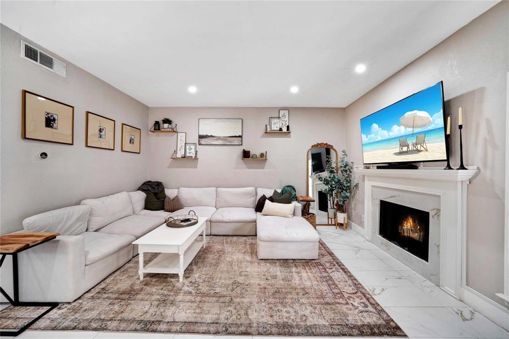 8518 Coppertowne Lane Dallas, TX 75243 - Photo 4 of 32 a living room with furniture and a fireplace