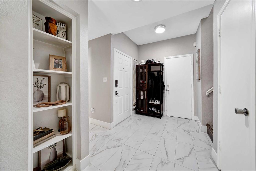 8518 Coppertowne Lane Dallas, TX 75243 - Photo 8 of 32 a view of walk in closet with clothes and shoes