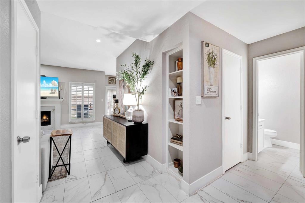 8518 Coppertowne Lane Dallas, TX 75243 - Photo 9 of 32 a kitchen with stainless steel appliances kitchen island granite countertop a refrigerator and a sink