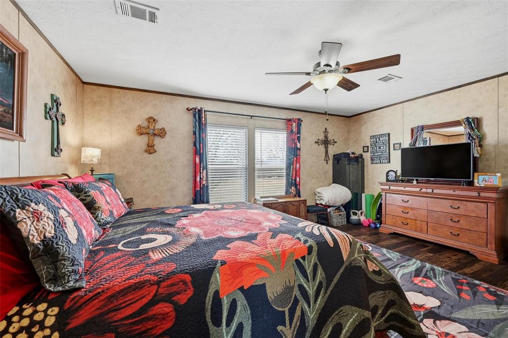 1949 Greer Road Sadler, TX 76264 - Photo 16 of 39 a bedroom with a bed and flat screen tv