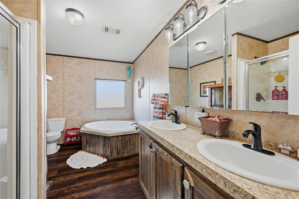 1949 Greer Road Sadler, TX 76264 - Photo 18 of 39 a bathroom with a granite countertop sink a toilet and a mirror