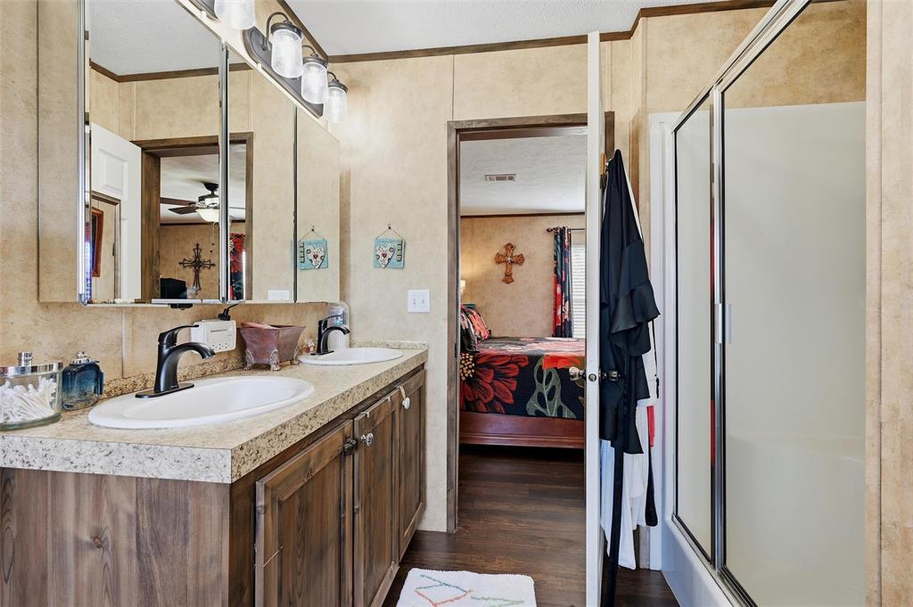 1949 Greer Road Sadler, TX 76264 - Photo 19 of 39 a bathroom with a granite countertop sink and a mirror