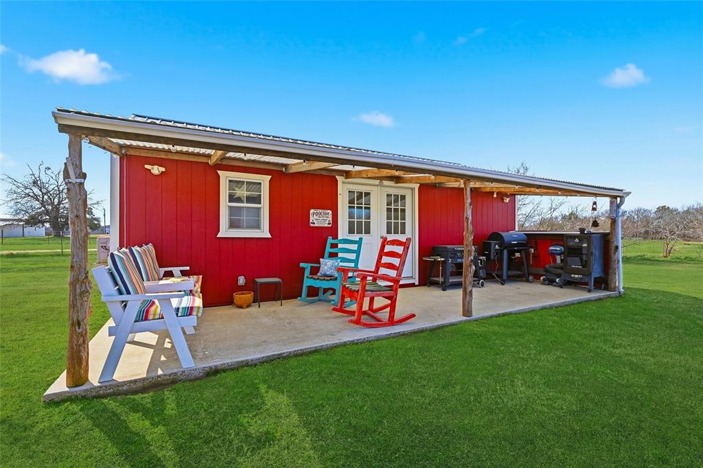 1949 Greer Road Sadler, TX 76264 - Photo 26 of 39 a view of a chairs and table in backyard of the house