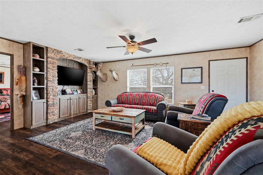 1949 Greer Road Sadler, TX 76264 - Photo 6 of 39 a living room with furniture and a flat screen tv