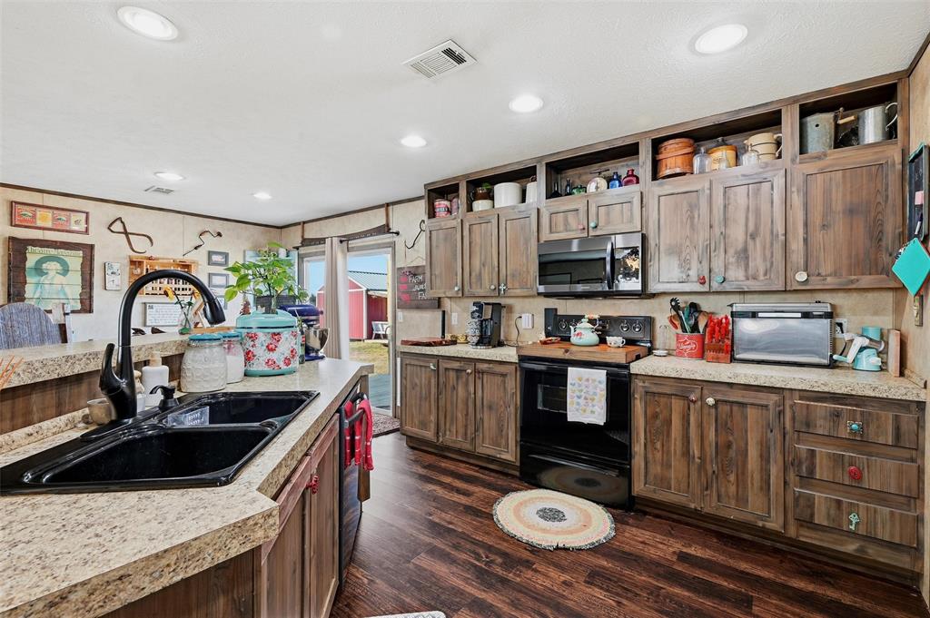1949 Greer Road Sadler, TX 76264 - Photo 10 of 39 a kitchen that has a sink and a stove in it