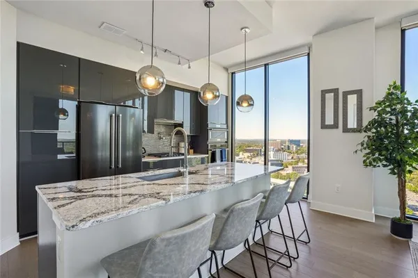 a kitchen with a table chairs refrigerator and microwave