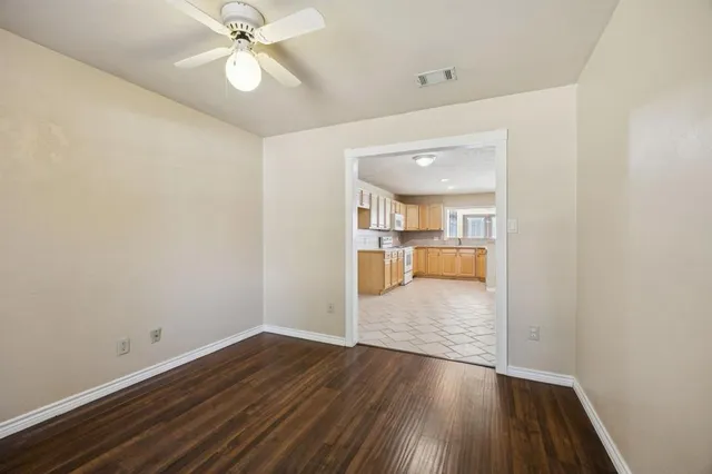 a view of a kitchen and wooden floor
