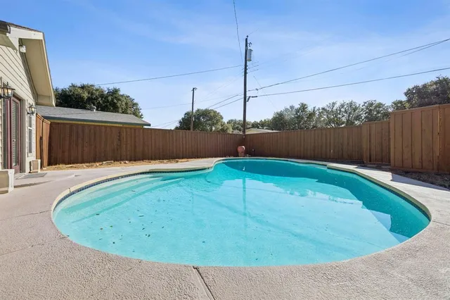 a view of a swimming pool with a chair