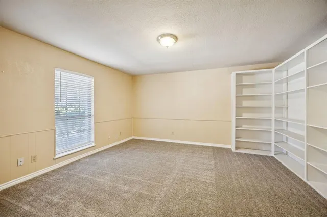 a view of an empty room with a empty shelves