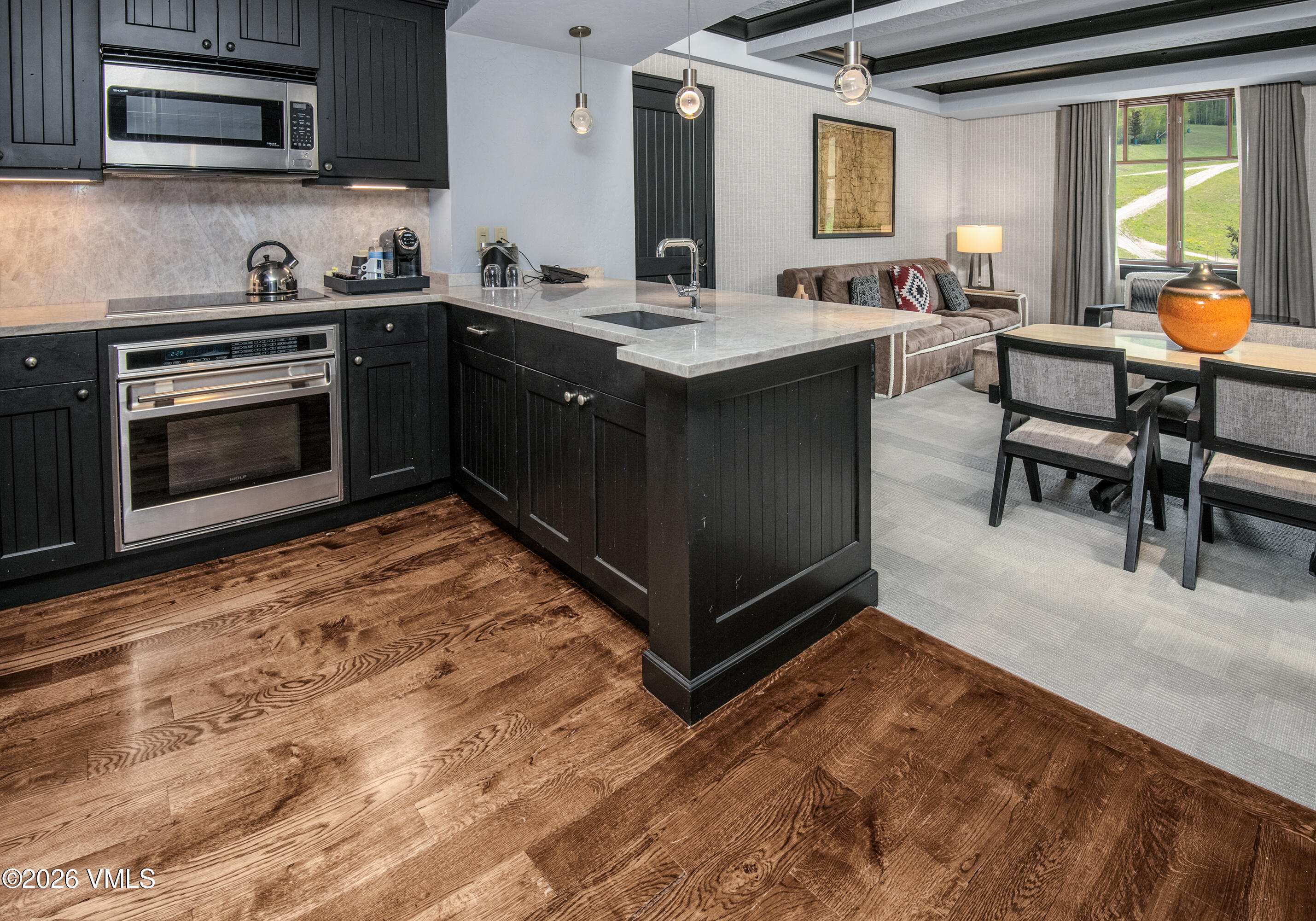 130 Daybreak Ridge Road, Unit HS716 Avon, CO 81620 - Photo 7 of 25 a kitchen with stainless steel appliances granite countertop a stove a sink and a microwave