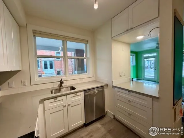 a kitchen with a refrigerator and a sink