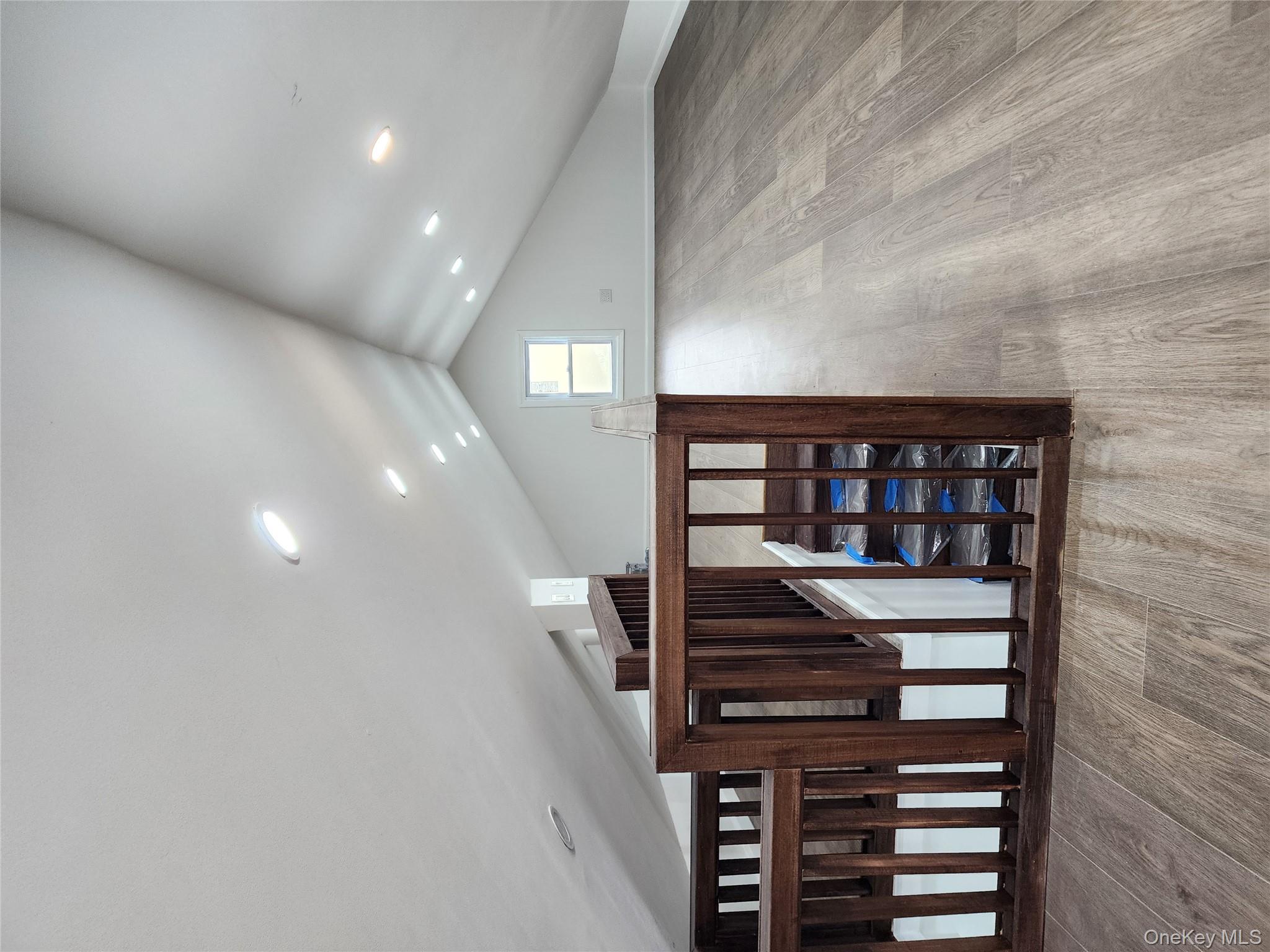 224-06 114th Road Queens, NY 11411 - Photo 9 of 15 Bonus room with wood finished floors, lofted ceiling, and recessed lighting