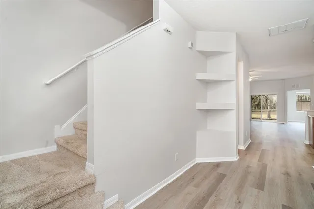 a view of hallway with wooden floor