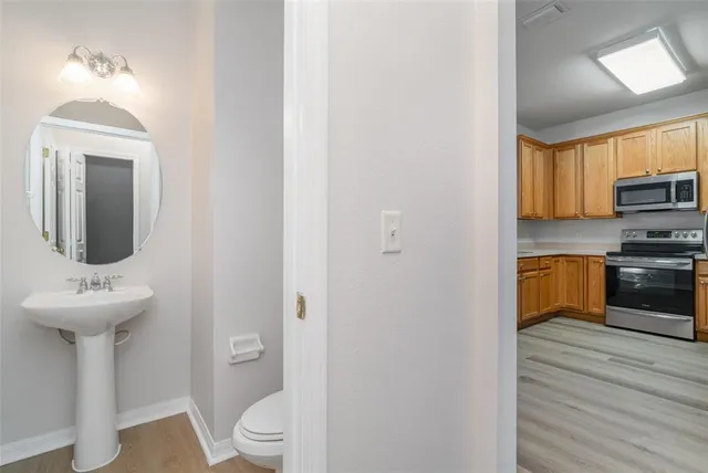 a bathroom with a sink a toilet and a mirror