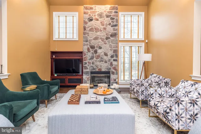 a living room with furniture fireplace and a fireplace