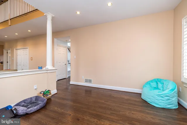 a room with wooden floor and a sink