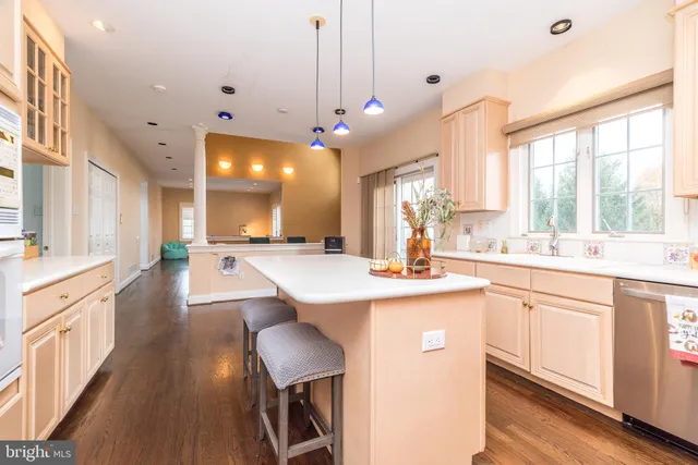 a large kitchen with lots of counter space a sink appliances and a large window