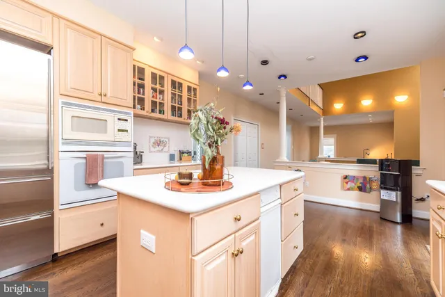 a kitchen with a sink and wooden floor