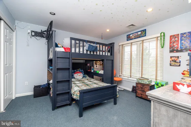 a bedroom with furniture and a window