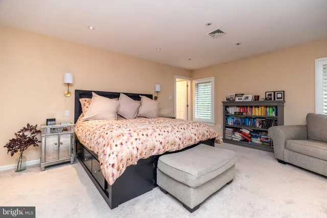 a bedroom with a bed a table and a couch