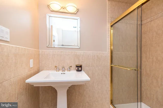 a bathroom with a sink a mirror and a shower