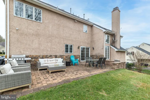 a view of backyard of house with seating space
