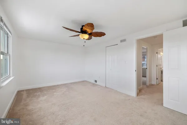 a view of a chandelier fan and closet in a room