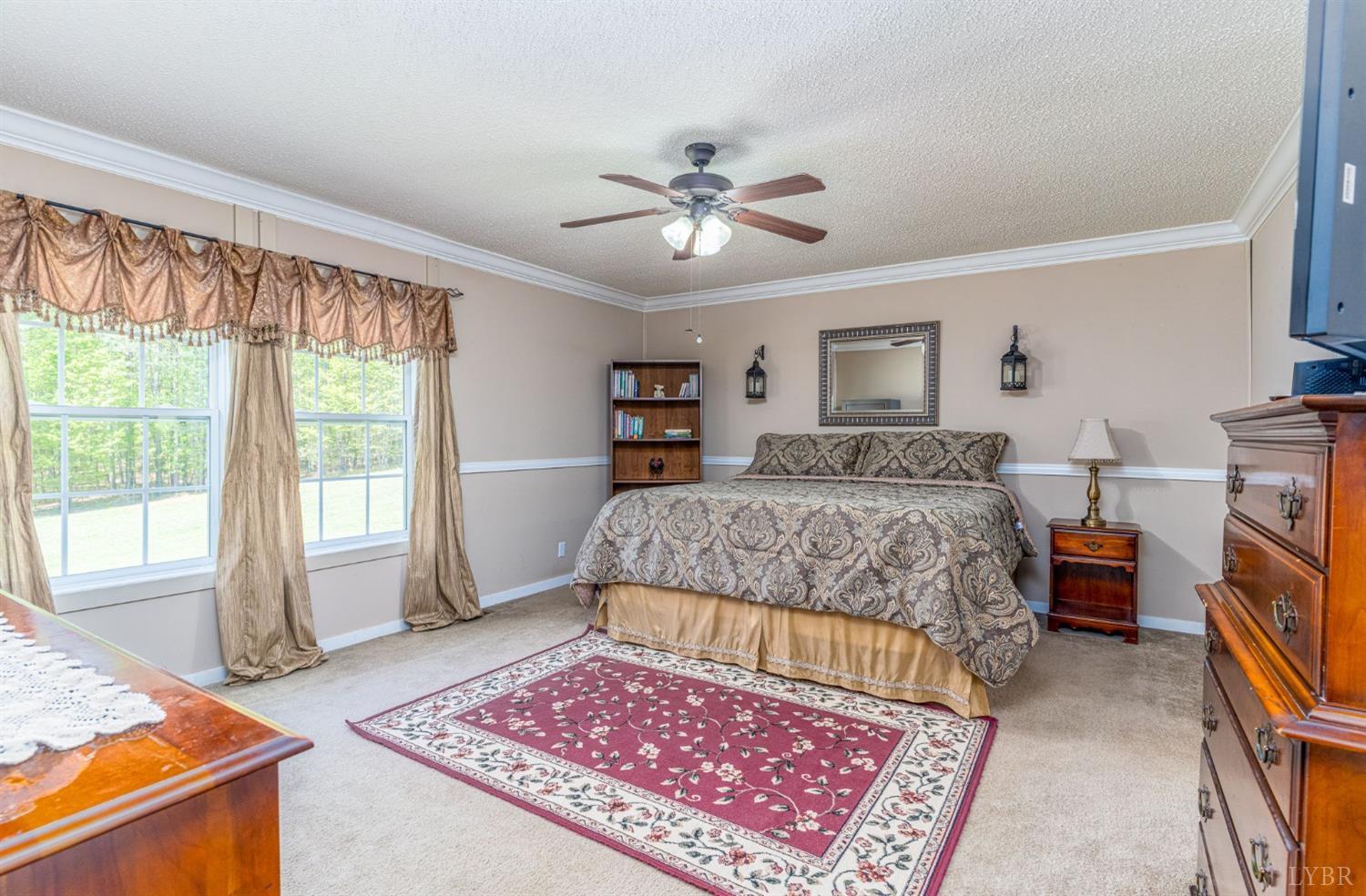 2570 Reedy Spring Road Spout Spring, VA 24593 - Photo 24 of 66 a bedroom with a bed and a chandelier