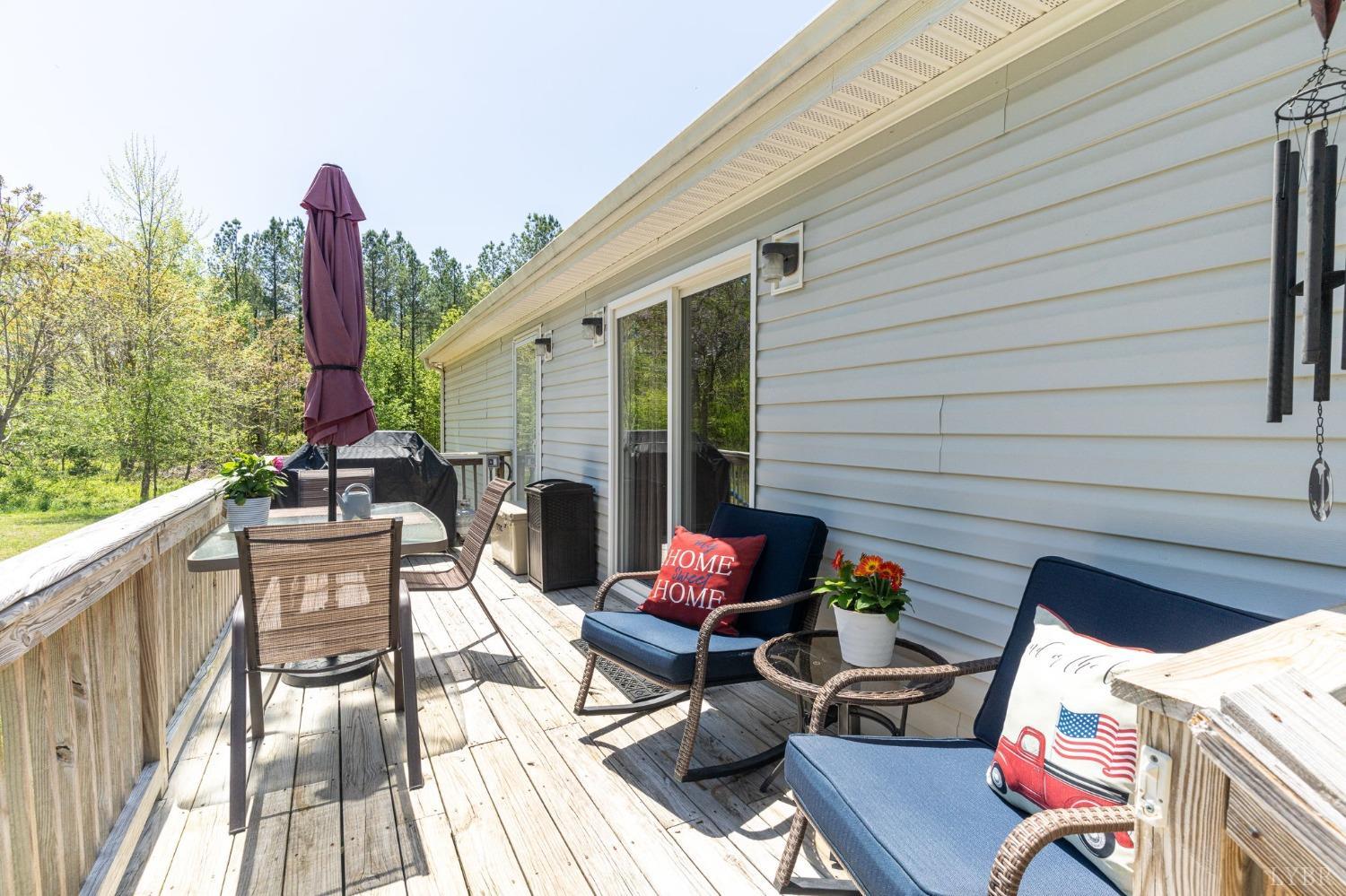 2570 Reedy Spring Road Spout Spring, VA 24593 - Photo 31 of 66 a patio with a table and chairs and potted plants