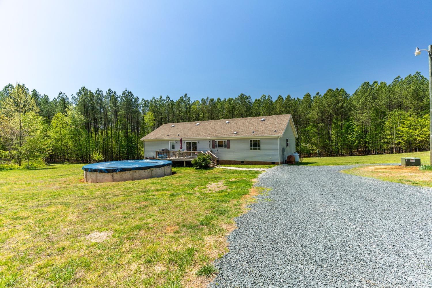 2570 Reedy Spring Road Spout Spring, VA 24593 - Photo 43 of 66 a view of a swimming pool and trees in the background