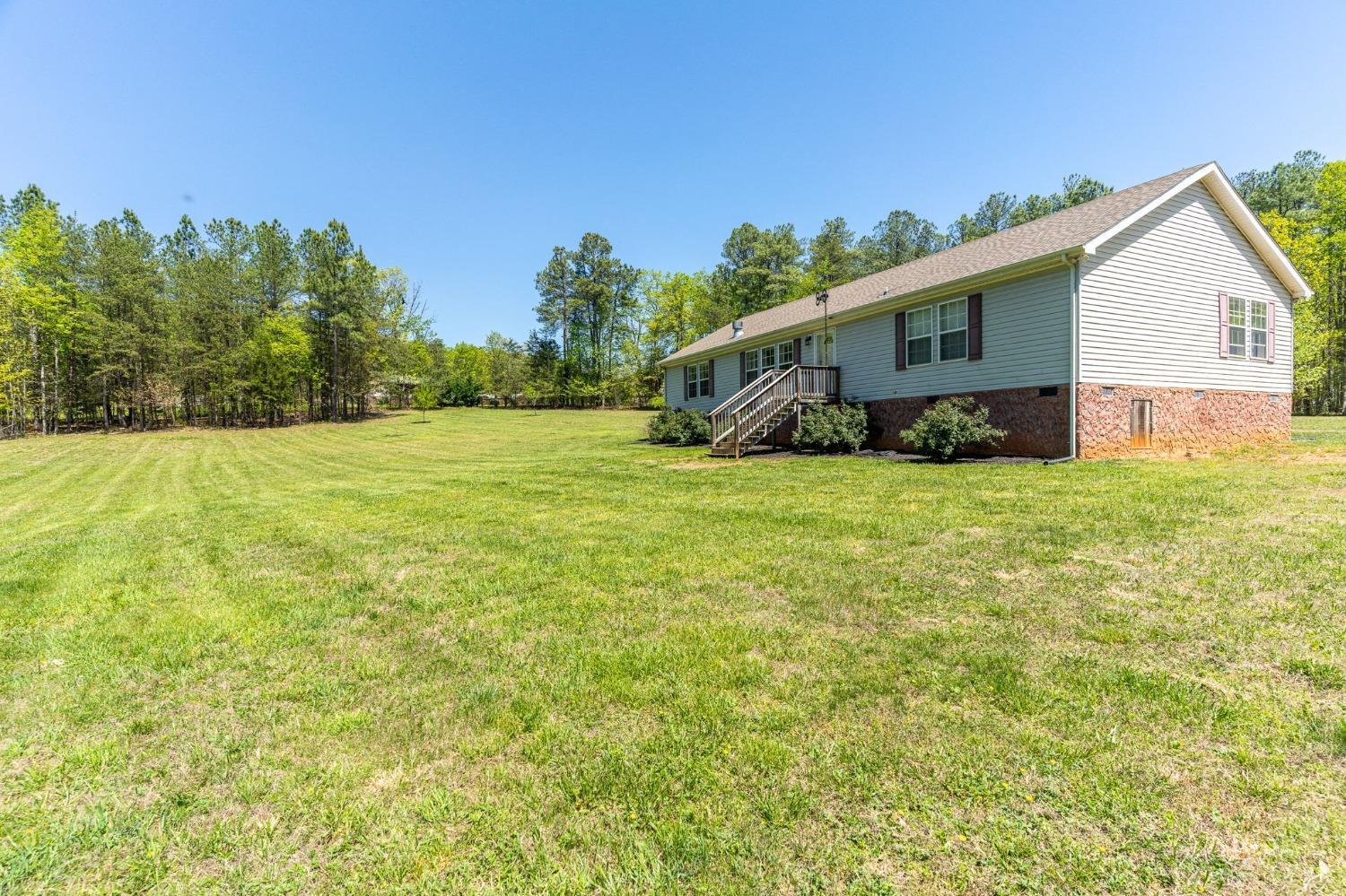 2570 Reedy Spring Road Spout Spring, VA 24593 - Photo 56 of 66 a view of a backyard with plants and large tree