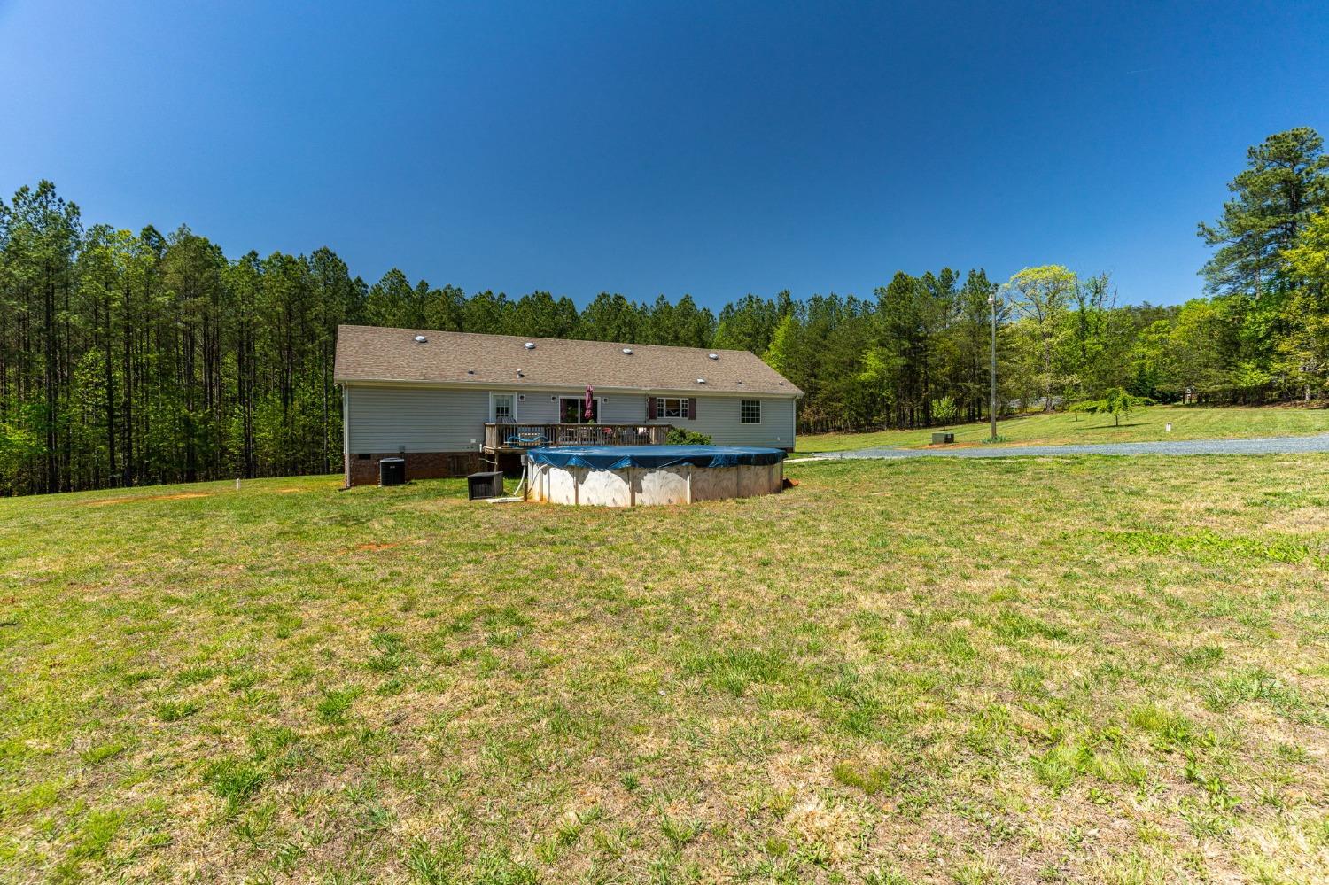 2570 Reedy Spring Road Spout Spring, VA 24593 - Photo 60 of 66 a view of a big yard with swimming pool and trees