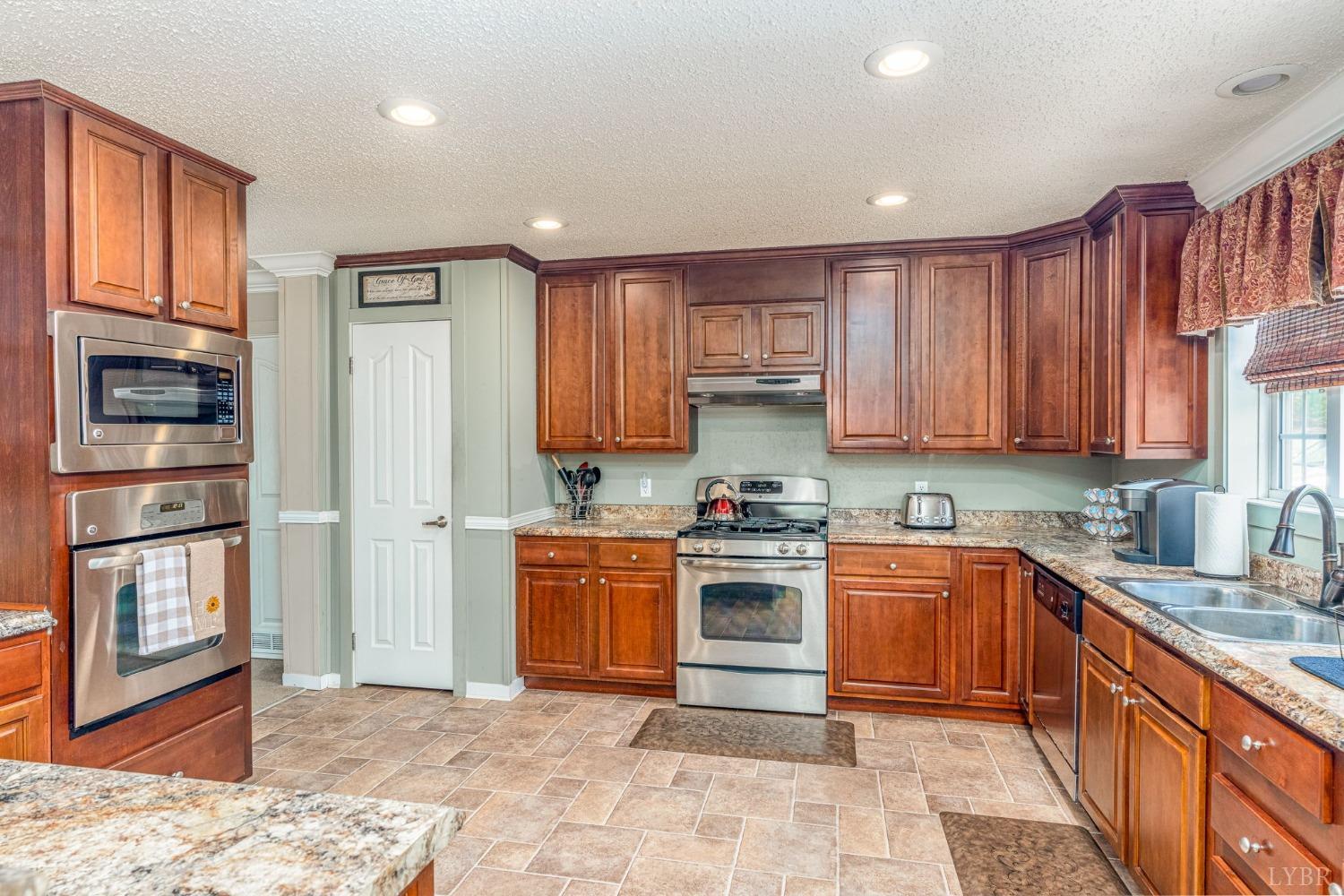 2570 Reedy Spring Road Spout Spring, VA 24593 - Photo 8 of 66 a kitchen with stainless steel appliances granite countertop a refrigerator stove and sink