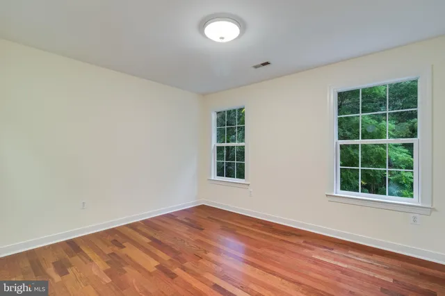 a view of a kitchen with a sink and wooden floor