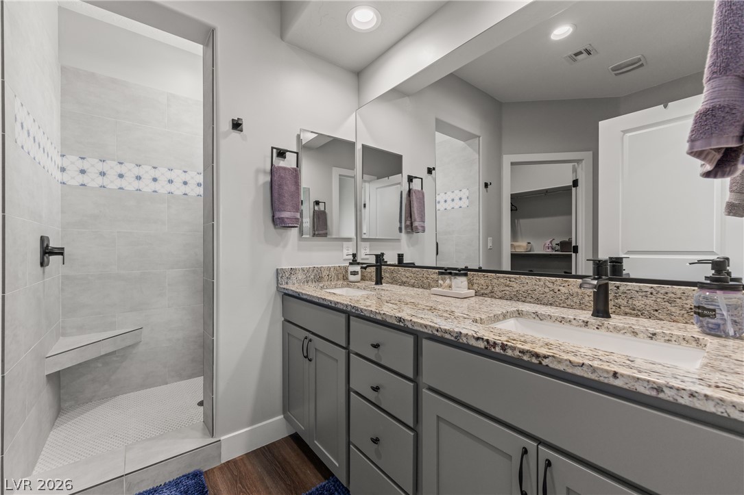 1436 Manassas Ridge Mesquite, NV 89027 - Photo 38 of 77 Double vanity with granite counters and rich wood flooring defines this well-appointed bathroom.