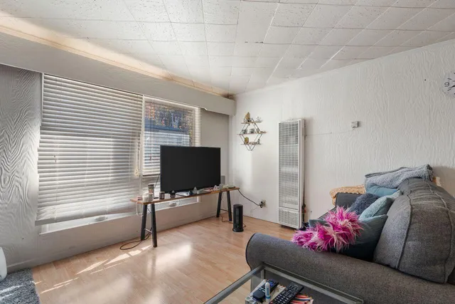 a bedroom with furniture and a flat screen tv