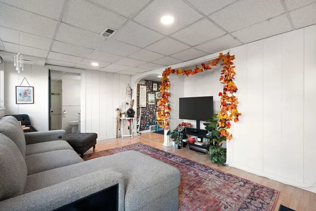 a room with furniture a flat screen tv and a window