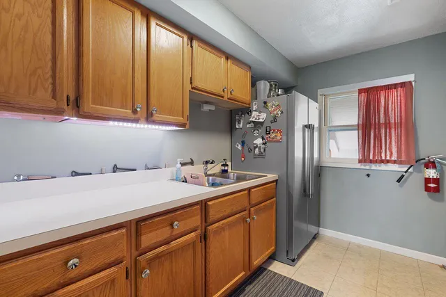 a kitchen with a stove and a white cabinets