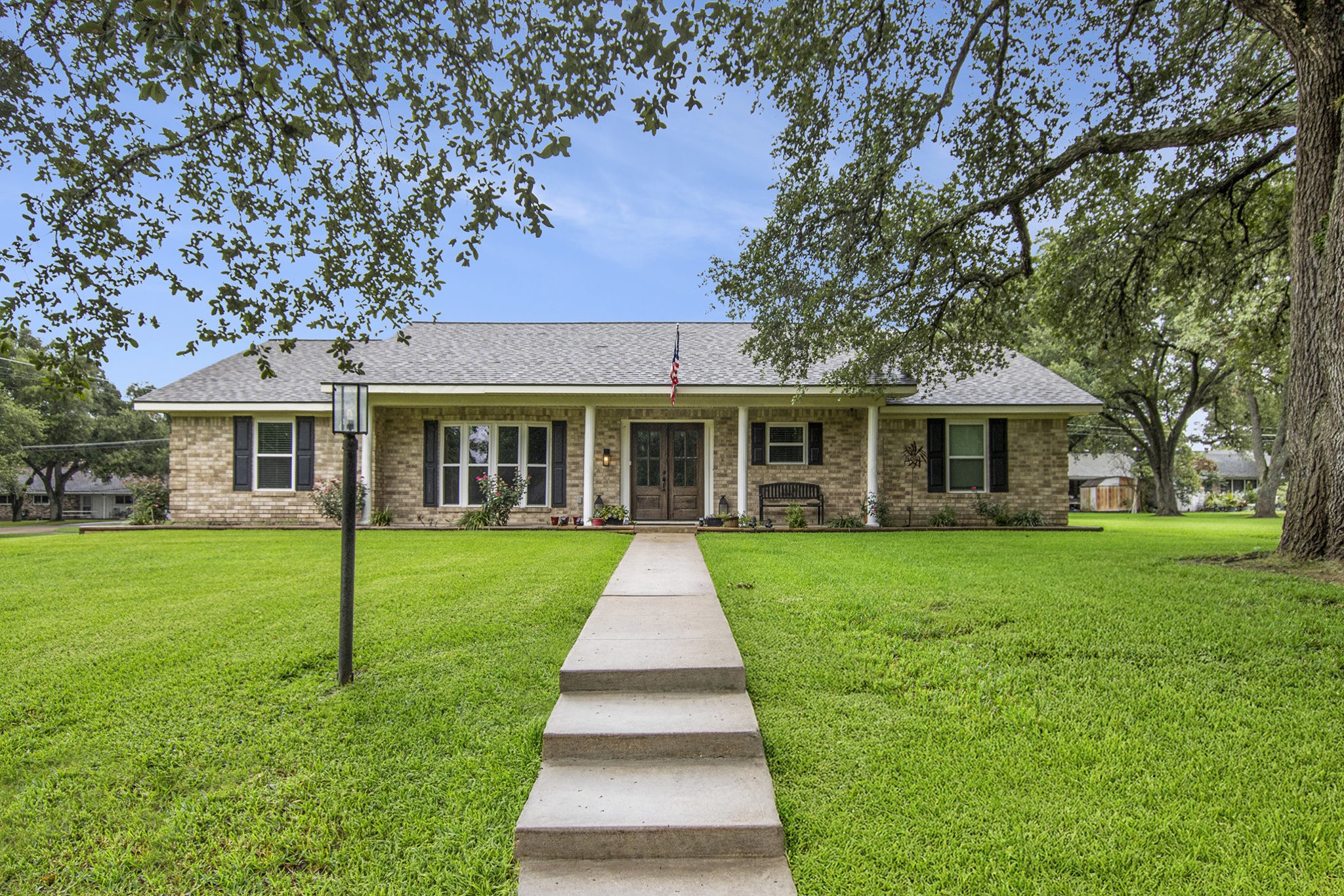 a view of a house with a yard and garden