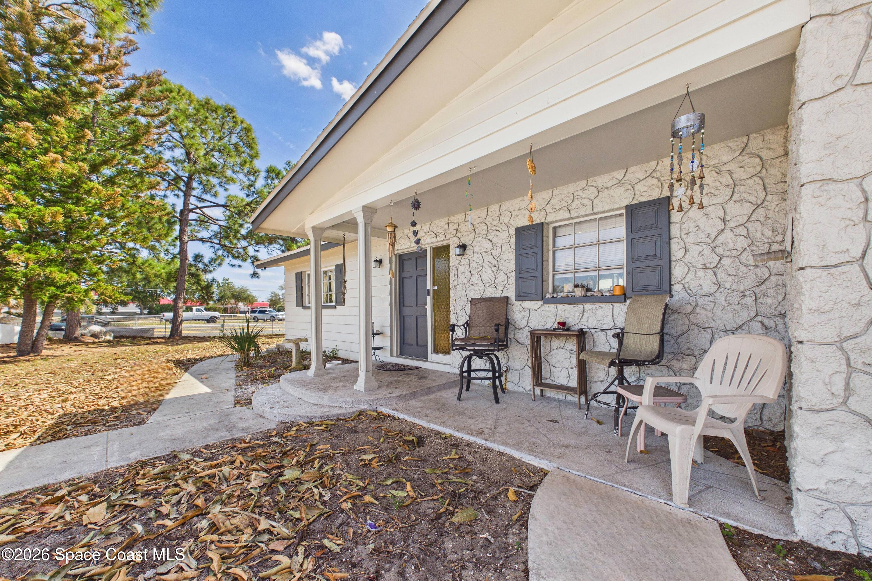 1300 Lester Court Merritt Island, FL 32952 - Photo 12 of 50 a outdoor space with lots of furniture and trees
