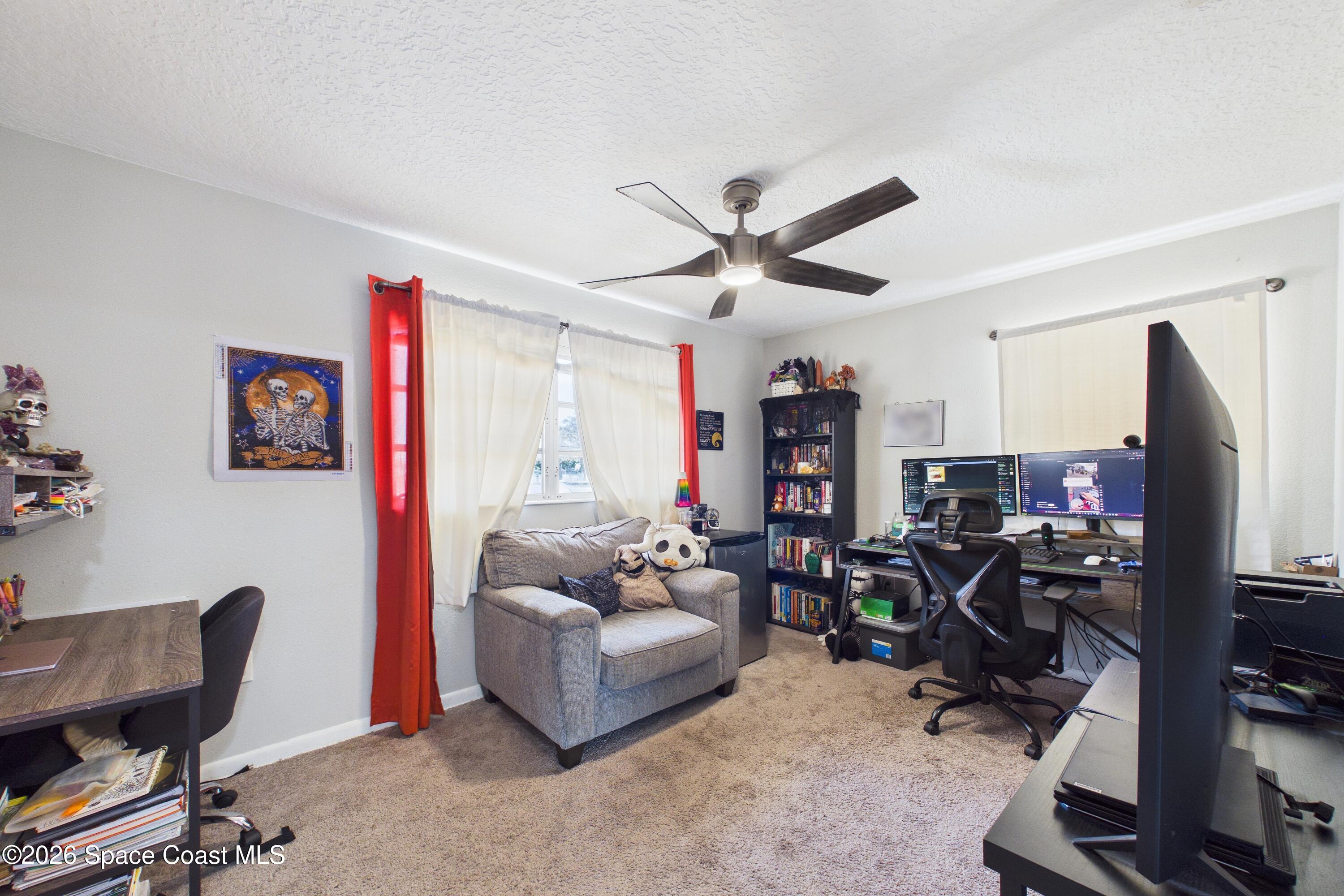 1300 Lester Court Merritt Island, FL 32952 - Photo 29 of 50 a living room with furniture a flat screen tv and a window