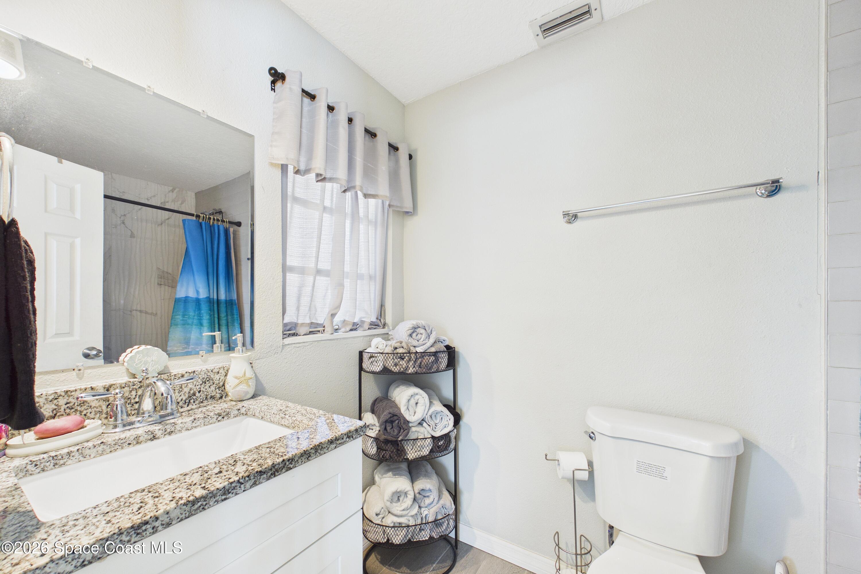 1300 Lester Court Merritt Island, FL 32952 - Photo 32 of 50 a bathroom with a sink vanity granite and toilet
