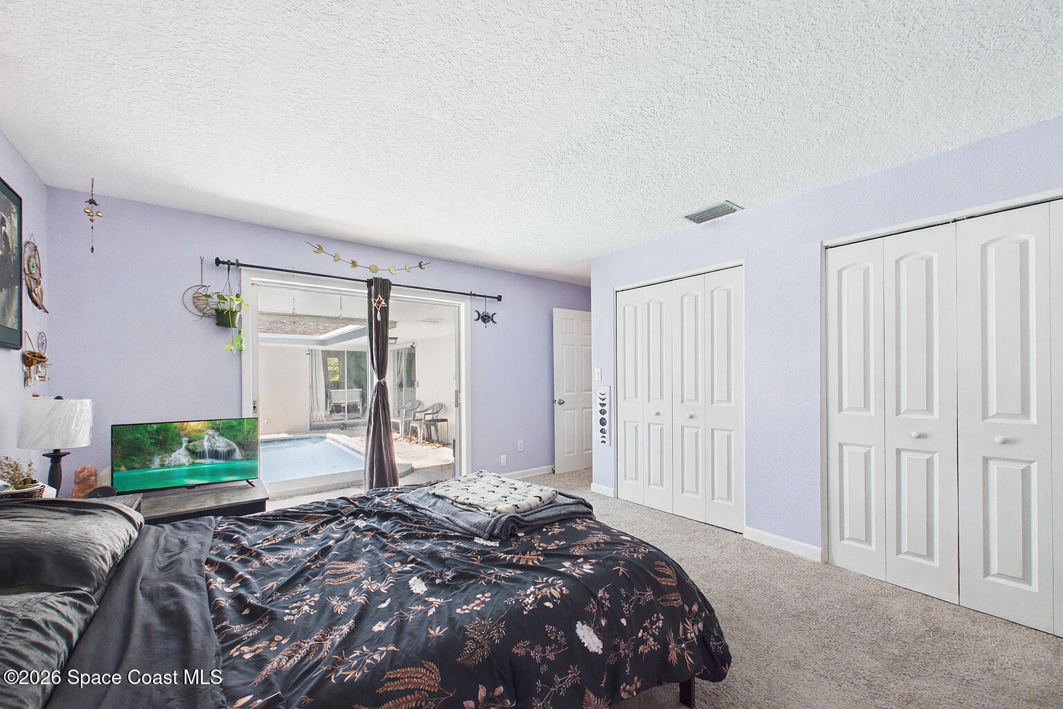 1300 Lester Court Merritt Island, FL 32952 - Photo 35 of 50 a bedroom with a large bed and a potted plant