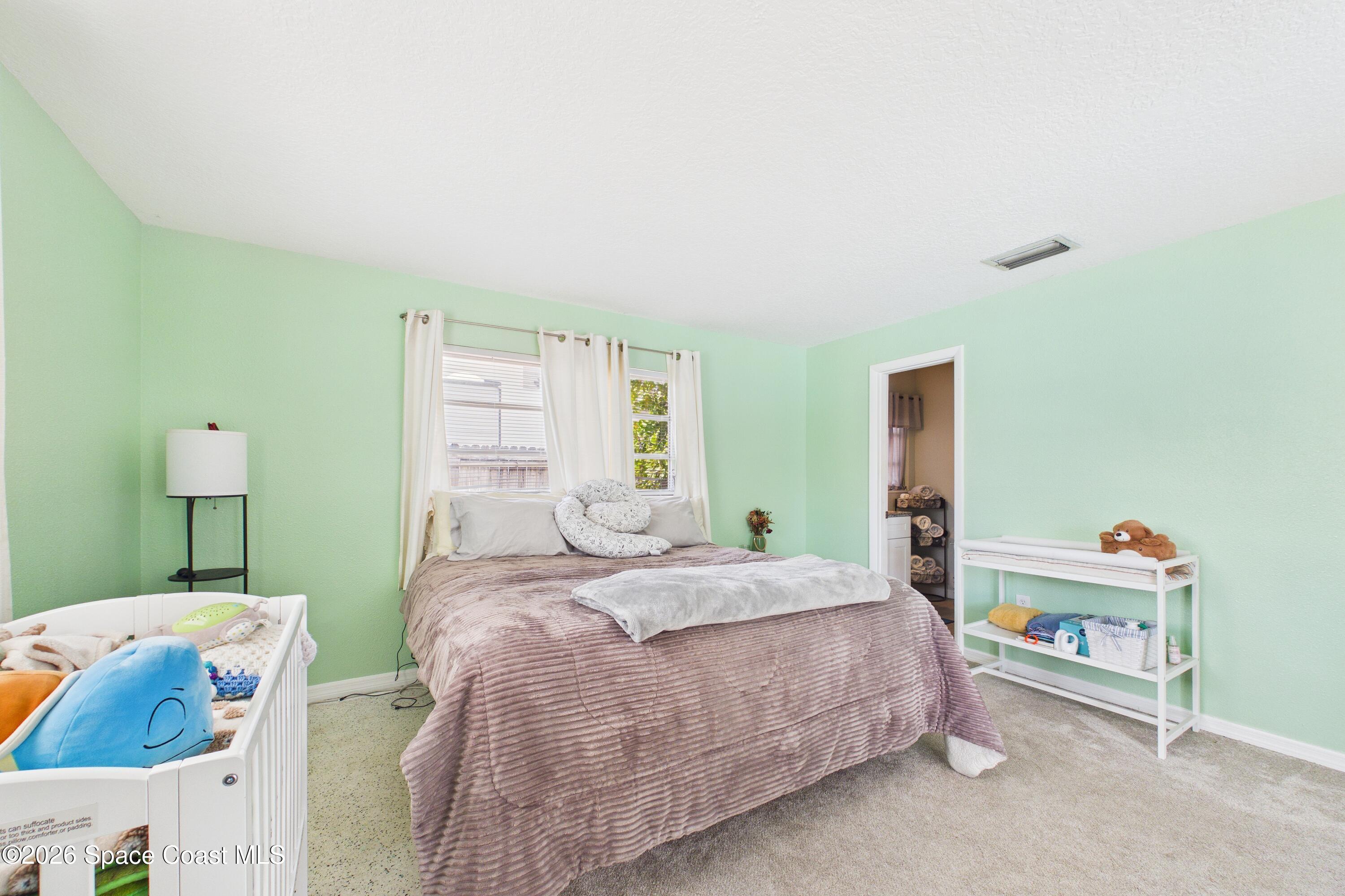 1300 Lester Court Merritt Island, FL 32952 - Photo 41 of 50 a bedroom with a bed and a window