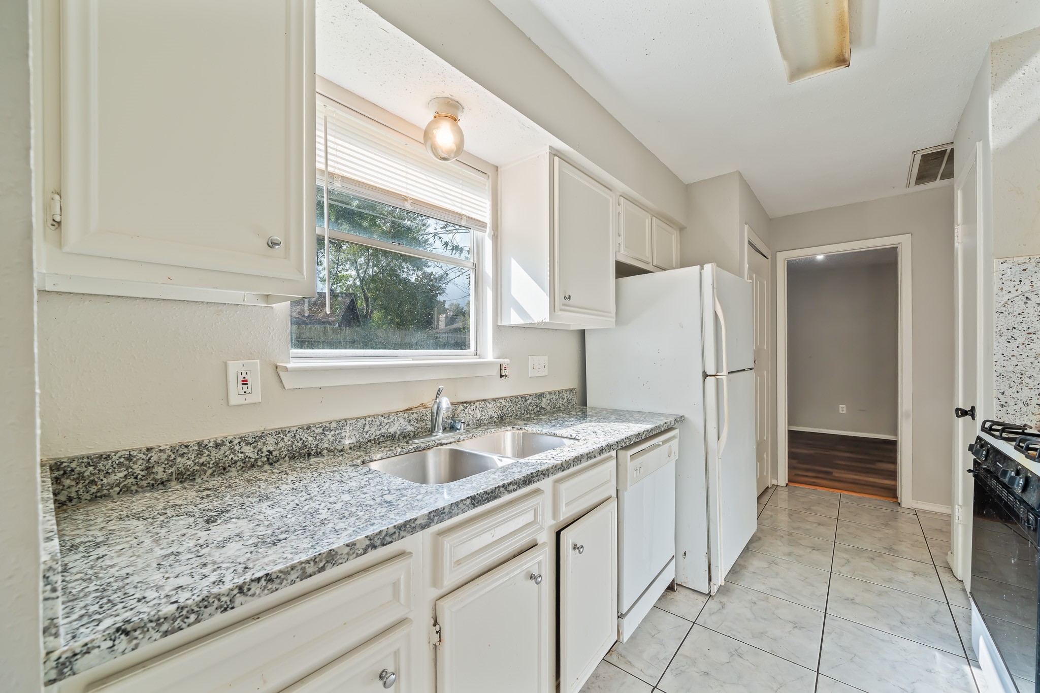 20115 Raingate Lane Katy, TX 77449 - Photo 11 of 25 a kitchen with a sink cabinets and stainless steel appliances