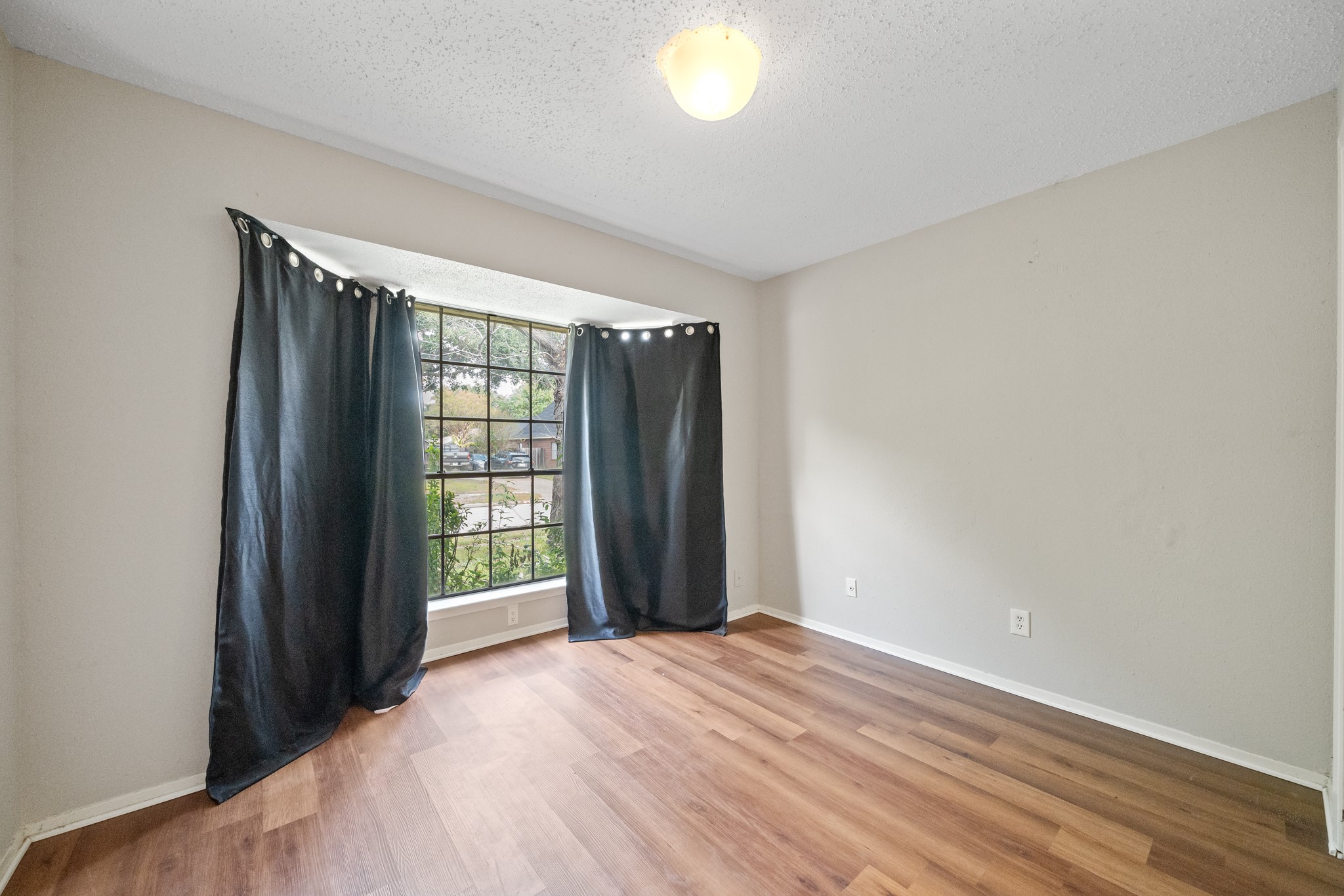 20115 Raingate Lane Katy, TX 77449 - Photo 12 of 25 a view of an empty room with wooden floor and a window