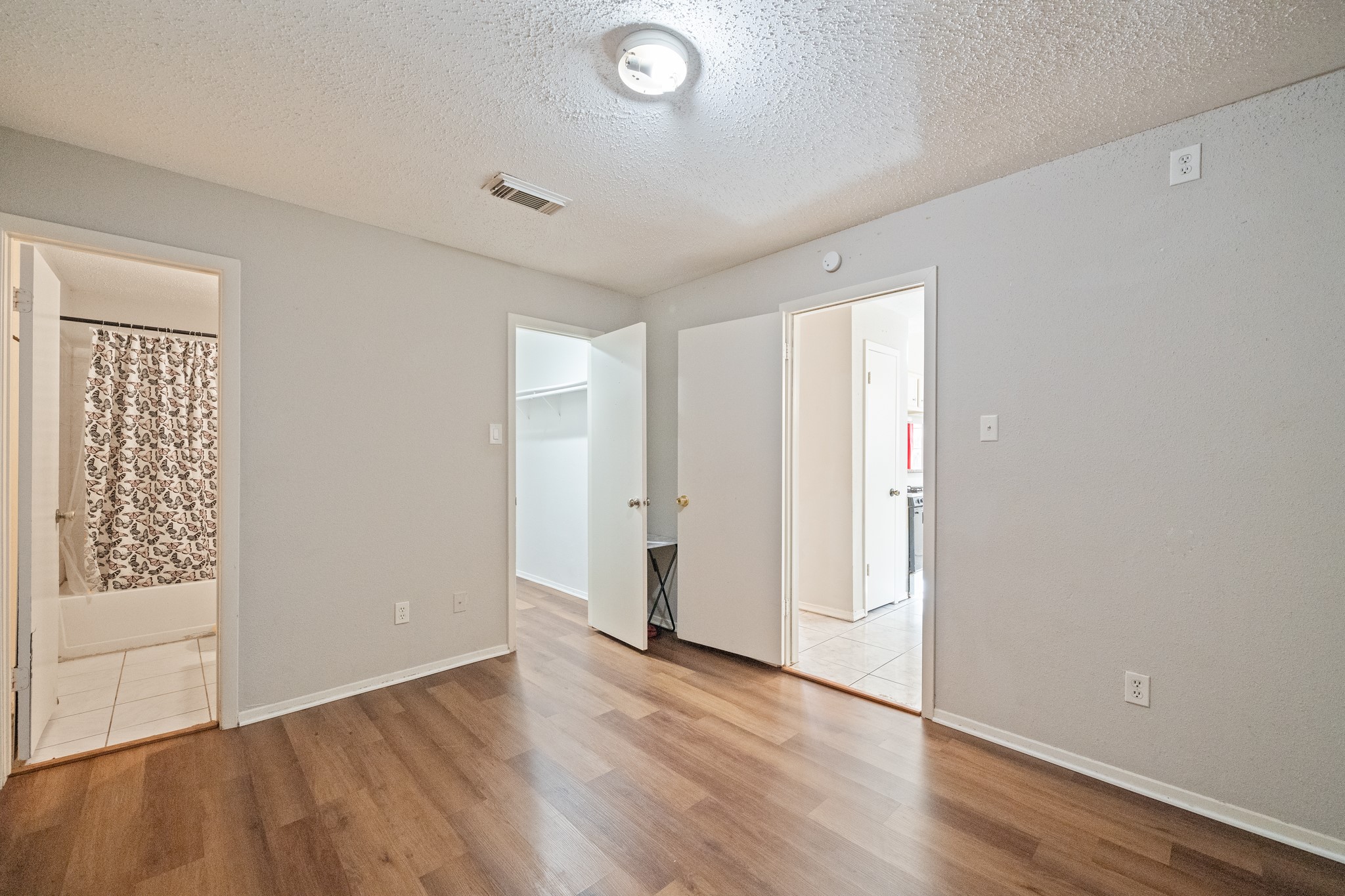 20115 Raingate Lane Katy, TX 77449 - Photo 20 of 25 an empty room with wooden floor and windows