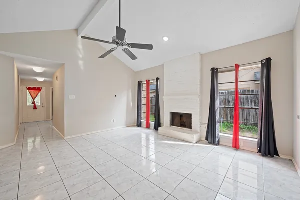 a view of empty room with cabinet and fireplace