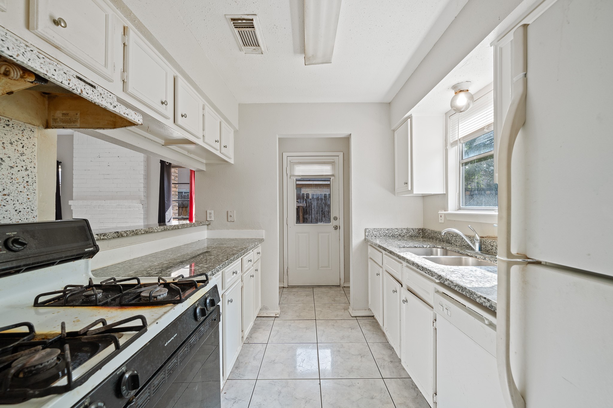 20115 Raingate Lane Katy, TX 77449 - Photo 10 of 25 a kitchen with a stove and a sink