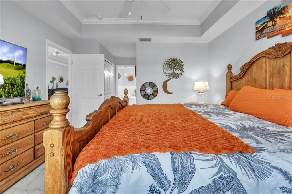 1260 Rio De Janeiro Avenue, Unit 102 Punta Gorda, FL 33983 - Photo 23 of 46 a bedroom with a bed and a lamp on dresser
